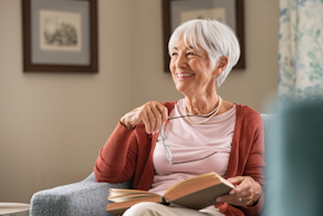 Life Assure Senior Woman Sitting In Chair And Laughing With Caregiver Nurse Blog